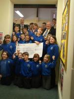 President Martin Love and Community and Vocation Chairman Clive Howells receive a cheque from Cantref Primary School as money raised at the Rotary Swimathon